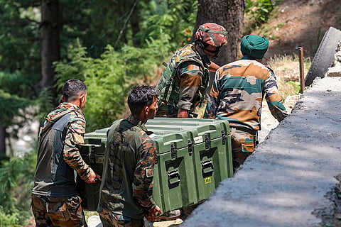 Army personnel carry weapons and equipments